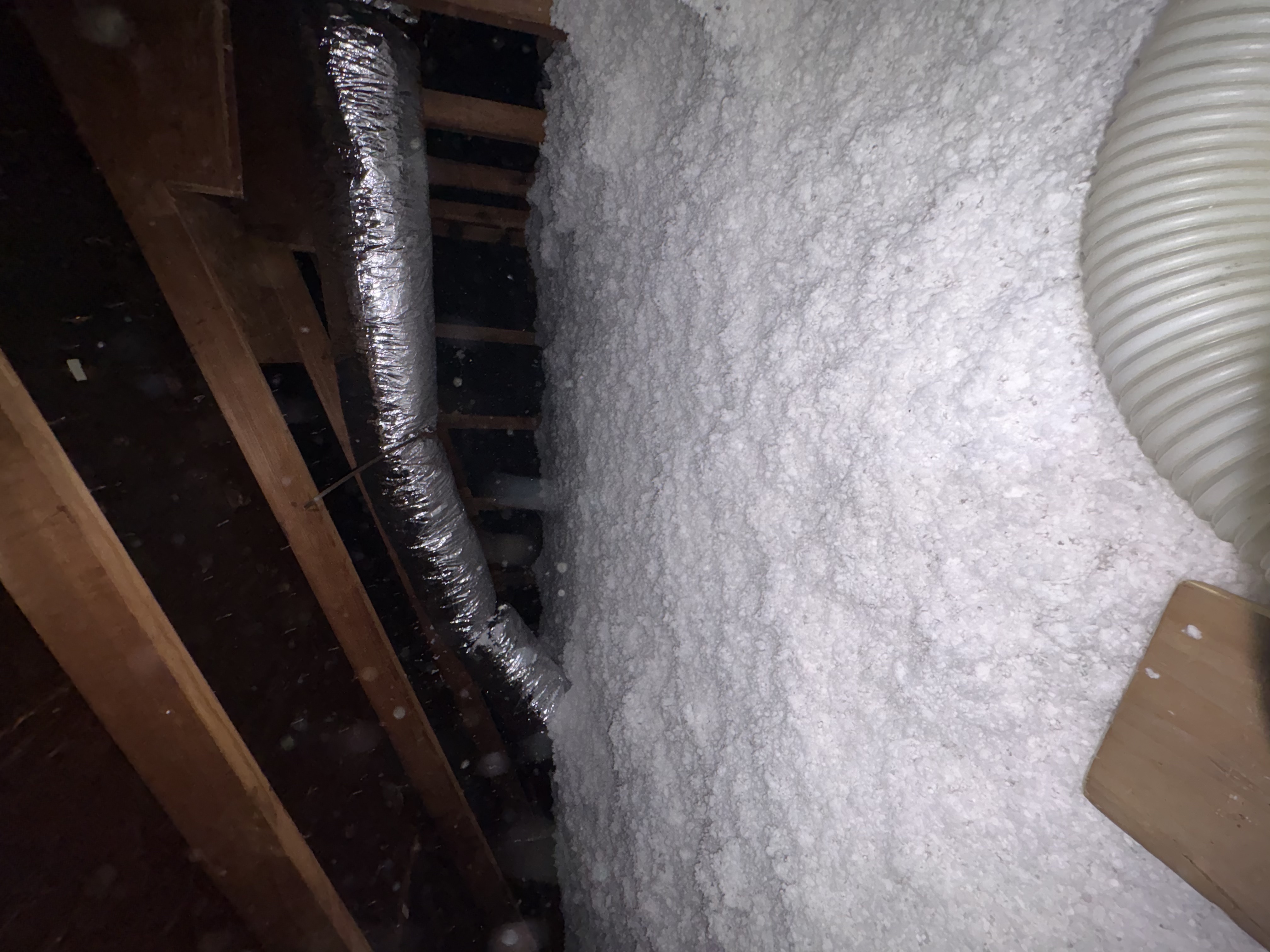 Fresh blown-in insulation installed evenly across an attic